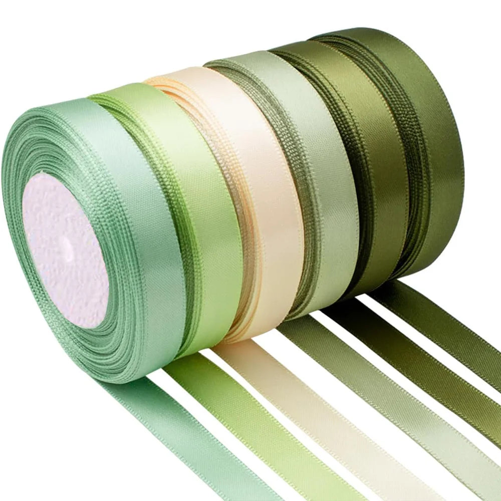 A roll of satin silk ribbon in various shades of green and beige, with several strips unwound.