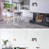 A white wall features a black metal key holder with hooks and a light pink pendant lamp.