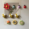 A set of colorful reusable fridge magnets featuring flowers and bees on a white background.