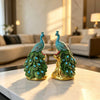 Elegant golden peacock statue with vibrant green feathers and blue crystal accents