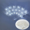 A silver LED dancing hand fan is shown open, emitting bright white light and creating a fan shape.
