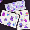 A collection of colorful laser cute magic witch graffiti stickers and decorative elements on a notebook and keyboard.