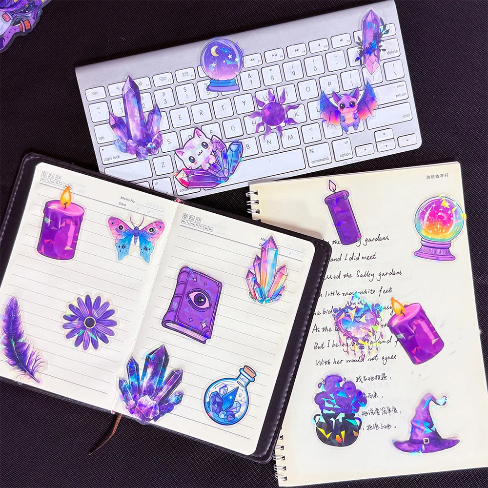 A collection of colorful laser cute magic witch graffiti stickers and decorative elements on a notebook and keyboard.