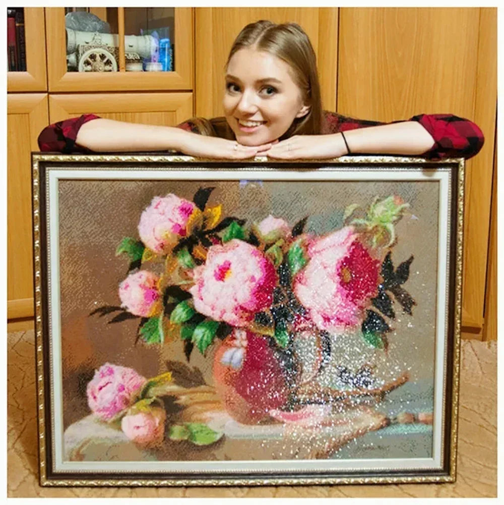 A diamond painting kit featuring a vibrant floral arrangement with pink and red flowers.