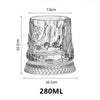 A clear crystal whiskey glass with a relief design, showing its dimensions and shape.