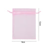 A rectangular pink organza drawstring gift bag with a 12cm height and 9cm width.