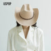 A woman wearing a classic beige wool cowboy hat with a studded leather band and a white collared shirt.