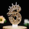 Gold glitter number cake topper featuring a number 6 with a rhinestone crown and bow