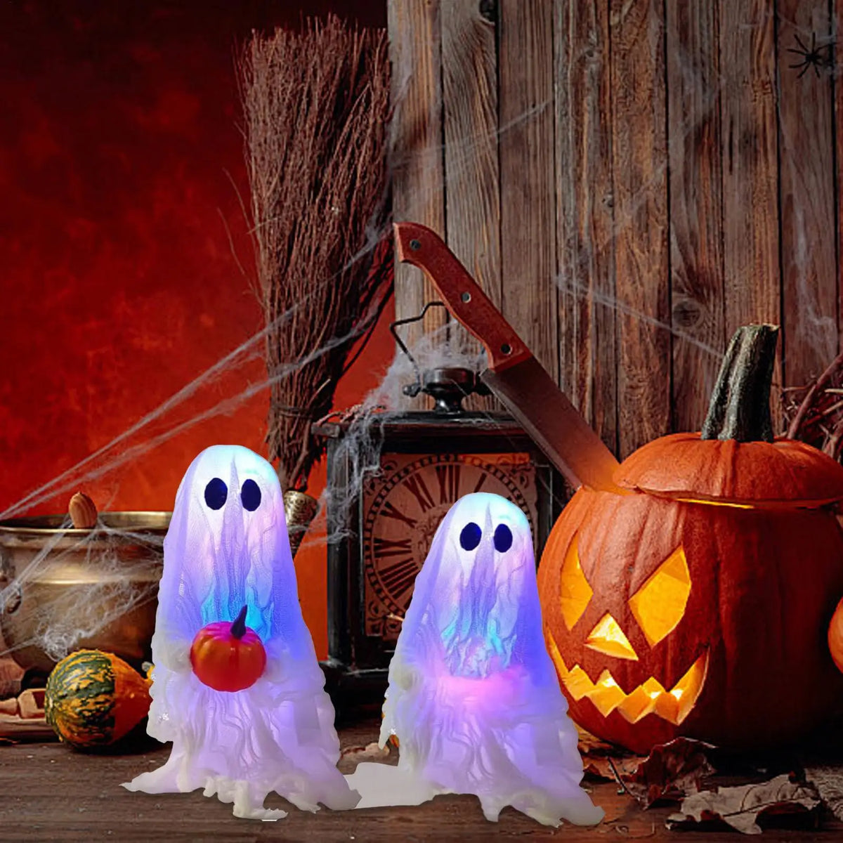 A set of glowing white ghost decorations in front of a carved pumpkin and rustic wooden background.