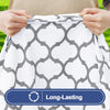 Hands adjusting a white patterned tablecloth with a gray geometric design for a folding table.