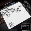 A white gaming mouse pad featuring a delicate black cherry blossom branch design on a dark surface.