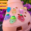 A pink resin charm holder with various glow-in-the-dark fruit turtle animals and other charms displayed outdoors.