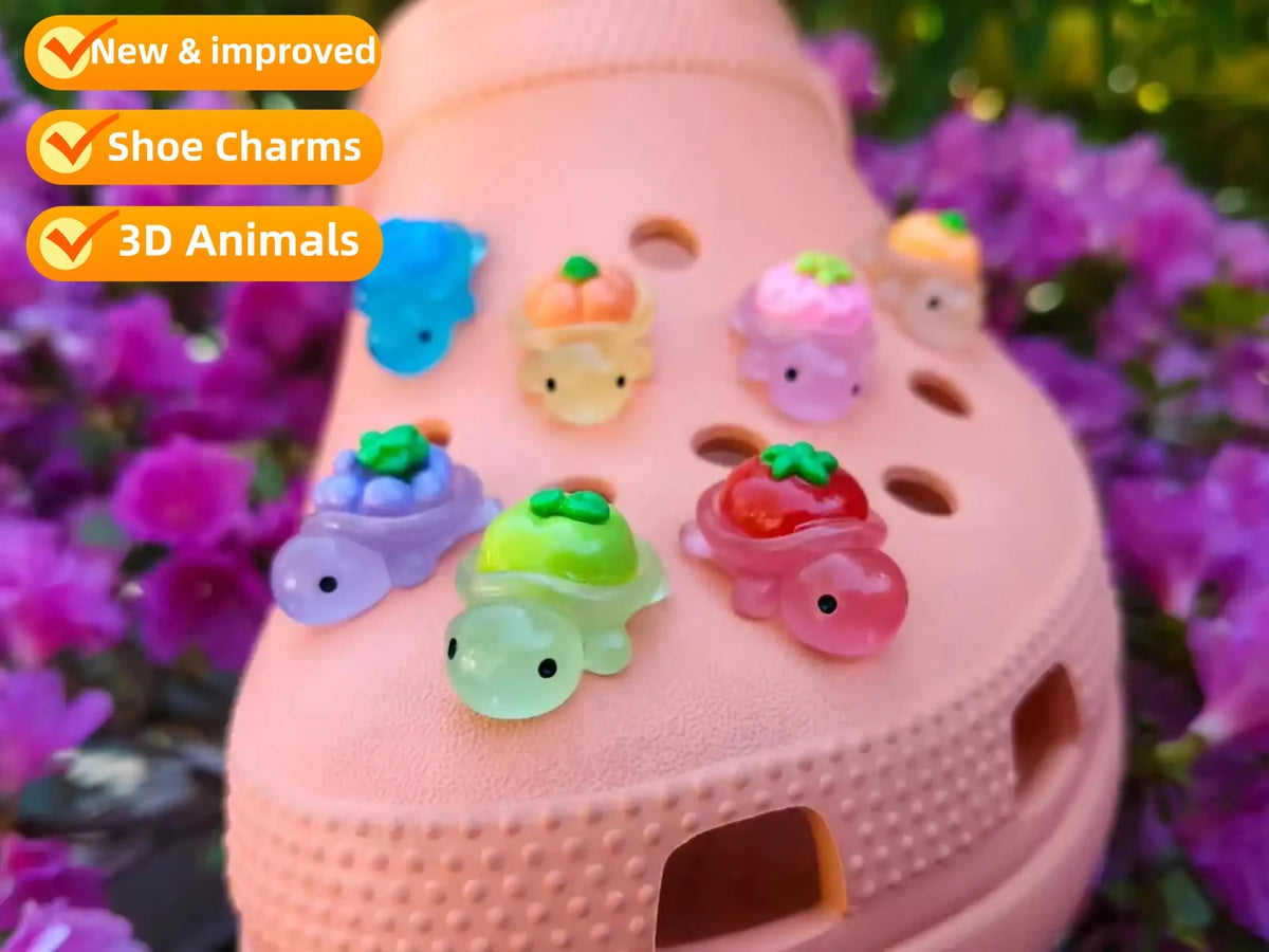A pink resin charm holder with various glow-in-the-dark fruit turtle animals and other charms displayed outdoors.