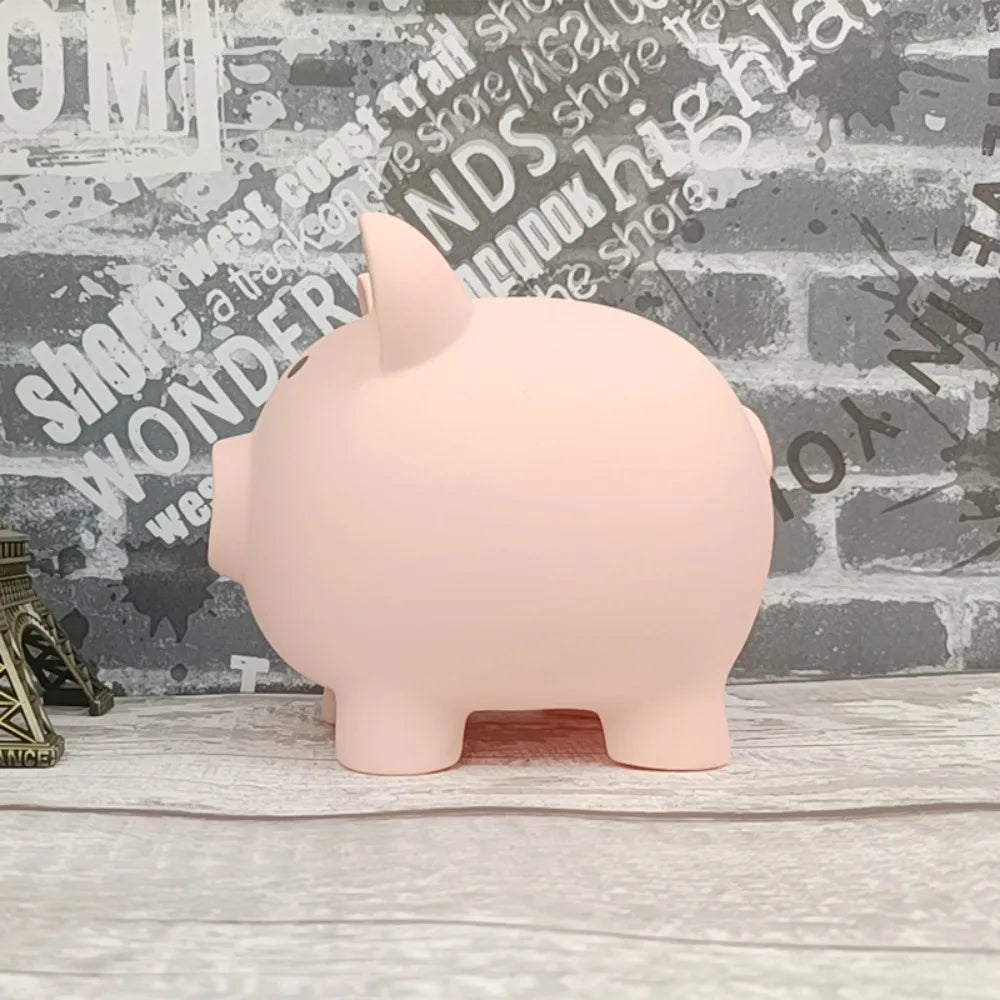 A pink piggy bank shaped like a pig is displayed on a wooden surface against a brick background.