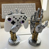 A gray and gold 3D gamepad controller storage organizer featuring a hand-shaped holder.