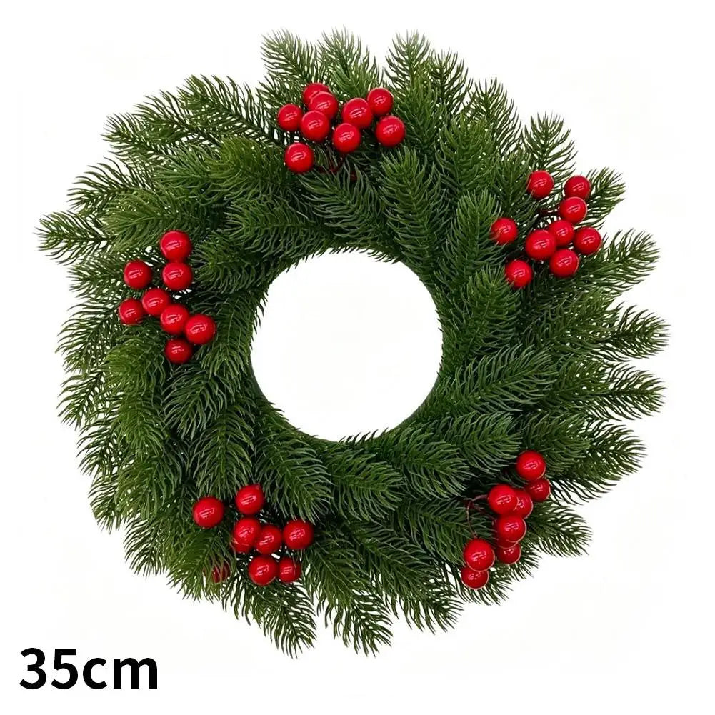 Green artificial Christmas wreath decorated with red berries and a velvet bow