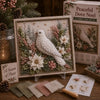 A 3D fabric poke art kit featuring a white bird in a winter forest scene with greenery and flowers.