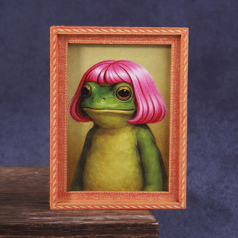 A painting of a pink-haired frog in a wooden photo frame.