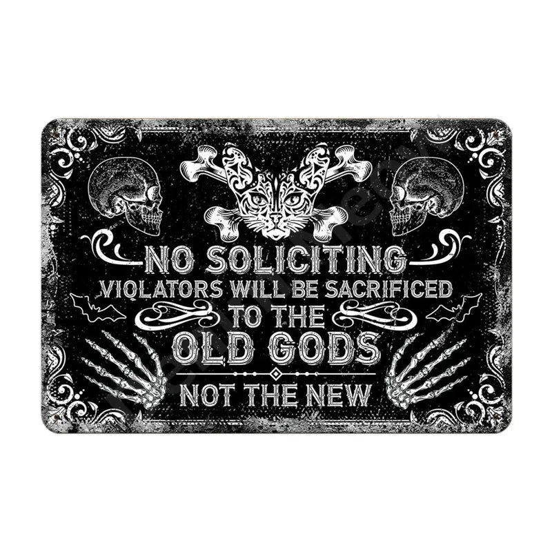 A black metal wall sign featuring skulls and a fierce cat face with text that reads No Soliciting Violators Will Be Sacrifice