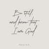 A black script rendering of Psalm 46:10 on a light gray background.