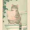 A tabby cat sits on a toilet tank, holding a newspaper, against a light green background with ivy.