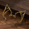 Gold elf flower leaf clip earrings for women displayed on a dark wooden surface