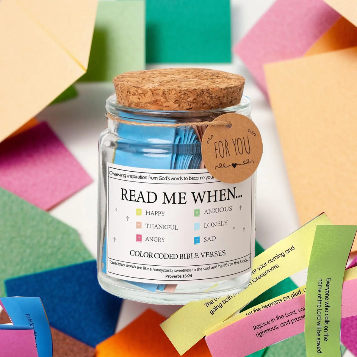 A glass jar filled with blue liquid and a cork, labeled for Bible verses.