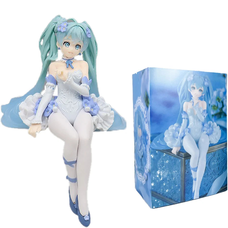 A PVC collectible figurine of Hatsune Miku in a light blue outfit with long teal hair and purple flowers.