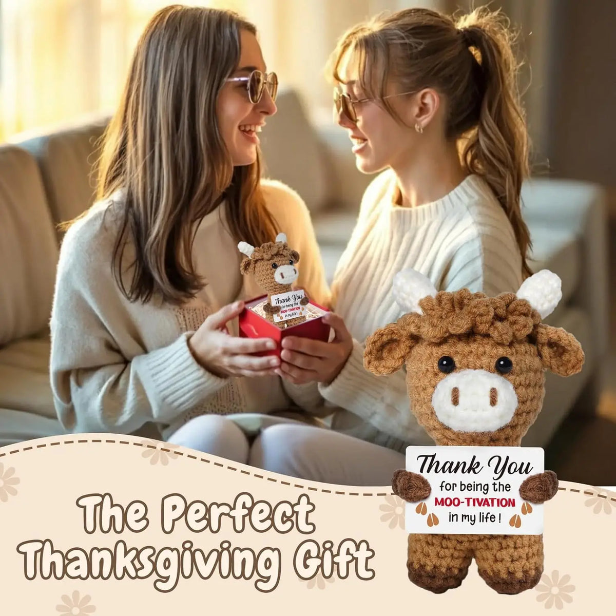 Two women smiling while holding a handcrafted crochet animal doll with a thank you message card