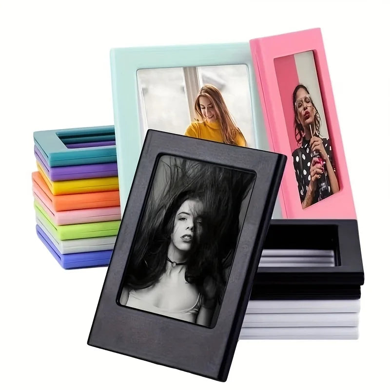 A black magnetic photo frame displaying a portrait, surrounded by colorful photo film stacks and pink and mint green frames.