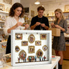 A woman displays an illuminated museum-style photo display case with figurines on a white table.