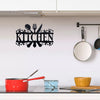 Rustic black metal word sign spelling out KITCHEN mounted on a white wall above a kitchen counter.