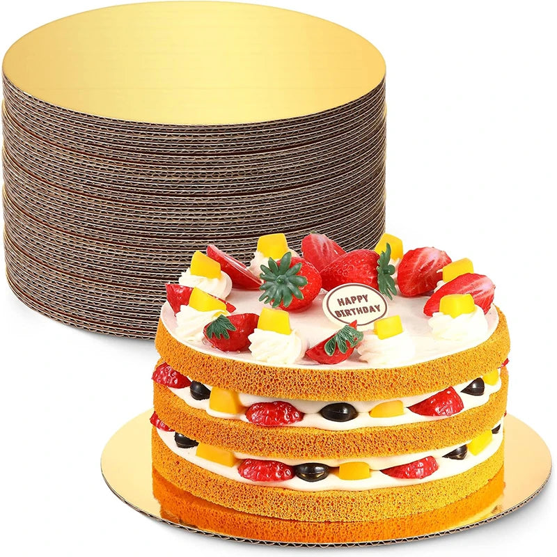 A round cardboard cake board with multiple layers of thin, gold-colored cardboard discs is shown next to a decorated strawber