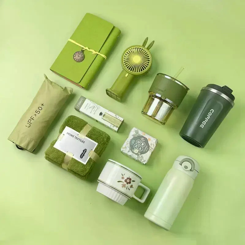 A green gift set featuring a tumbler, towel, and UPF sun protection item on a light green background.