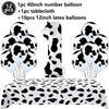 A set of cow print number balloons and a tablecloth for a farm-themed birthday party decoration.