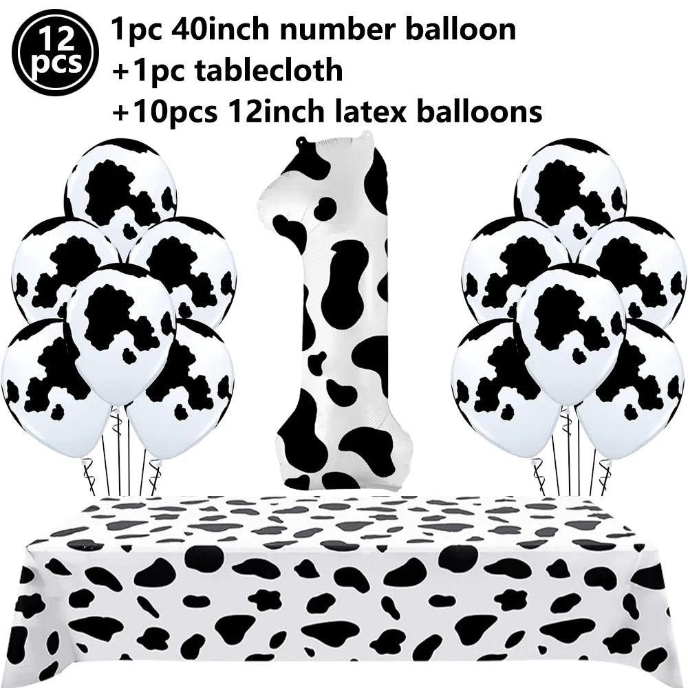 A set of cow print number balloons and a tablecloth for a farm-themed birthday party decoration.