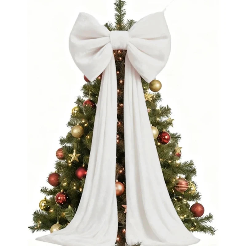 A Christmas tree decorated with gold and red ornaments and a large white bow and long streamers.