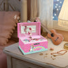 A pink unicorn music jewelry box with a rotating dancer figurine and musical notes on a wooden surface.