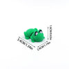A bright green 3D printed cartoon animal figurine, likely a frog or similar creature, shown with dimensions.