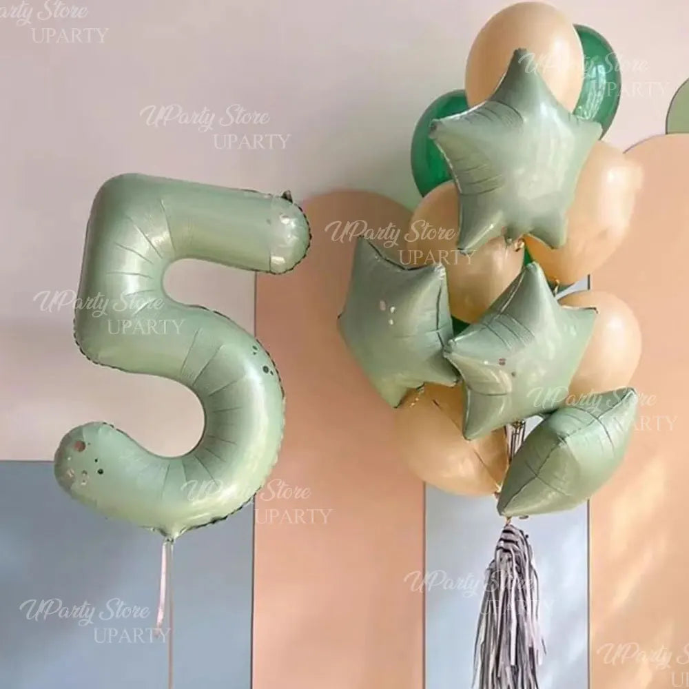 A large foil number 5 made of light green balloons is displayed next to a cluster of gold and green star-shaped balloons.