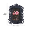 Black ornate resin photo frame with a pink rose design and dark background