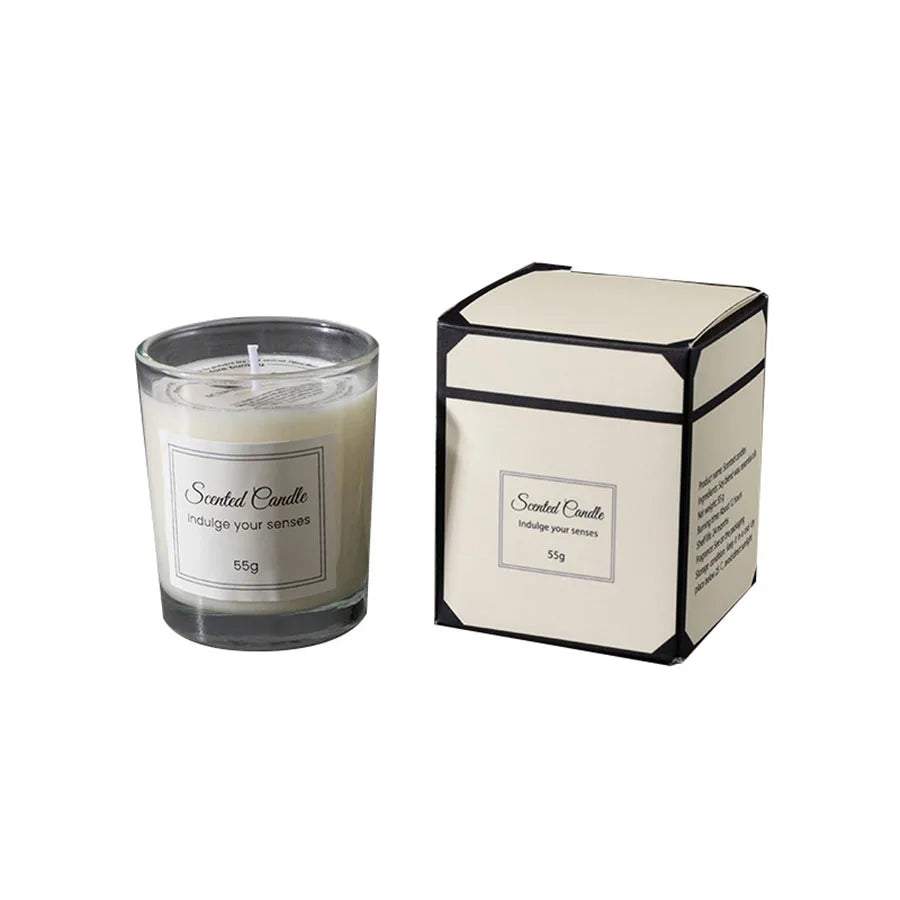 A rectangular candle in a cream and black box with a label, showing the 55g weight.
