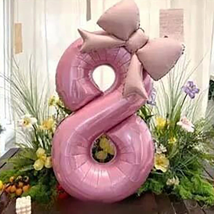 Two pink 32-inch number balloons shaped like the number 8 with matte bow decor