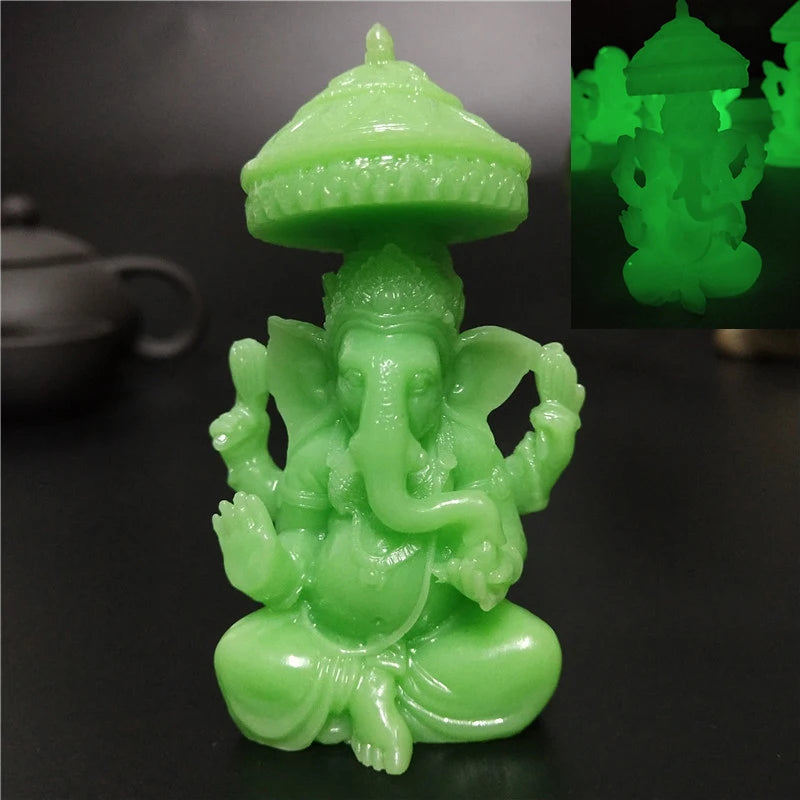 A bright green bronze Ganesha Buddha statue with a tiered crown and seated posture.