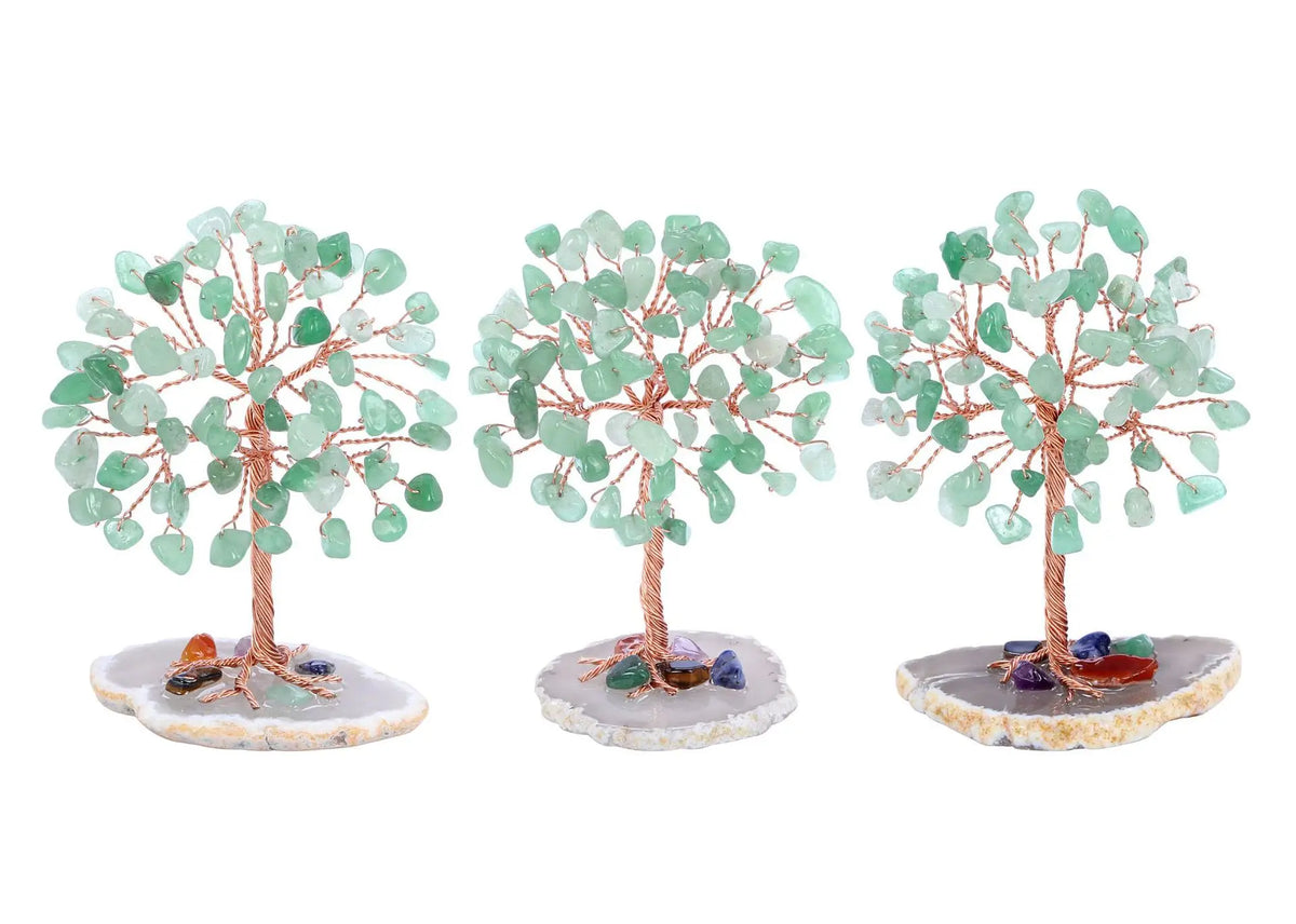 Three small crystal money tree decor plants with green leaves set on light colored bases.
