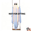 A white glowing ghost decoration hangs from a stand, with the text NOT FOR SITTING visible.