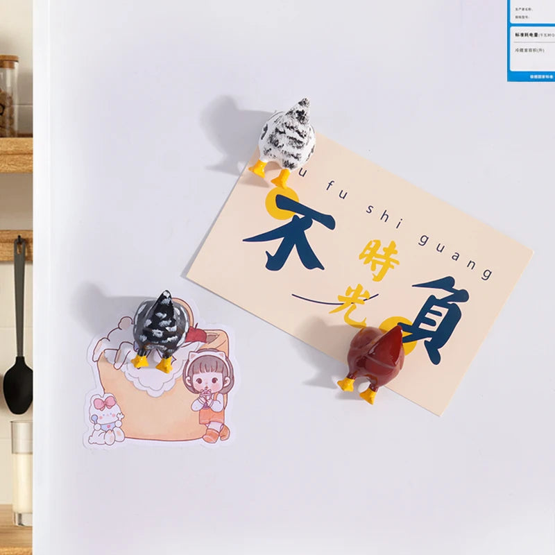 A set of three playful chicken butt fridge magnets featuring a chick, a hen, and a rooster, displayed on a light-colored card