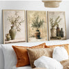 Three framed canvas prints featuring olive branches in antique pottery on a light background.