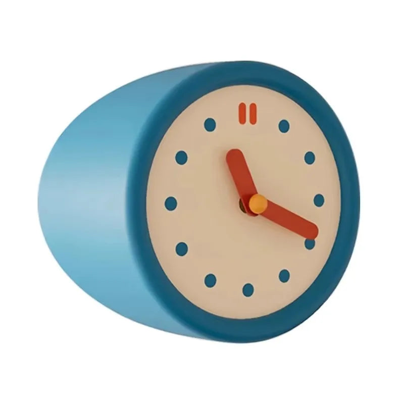 A round blue modern resin wall clock with a beige face and orange hands.