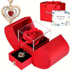 A red velvet box containing an elegant rose pendant necklace and a greeting card for best wishes